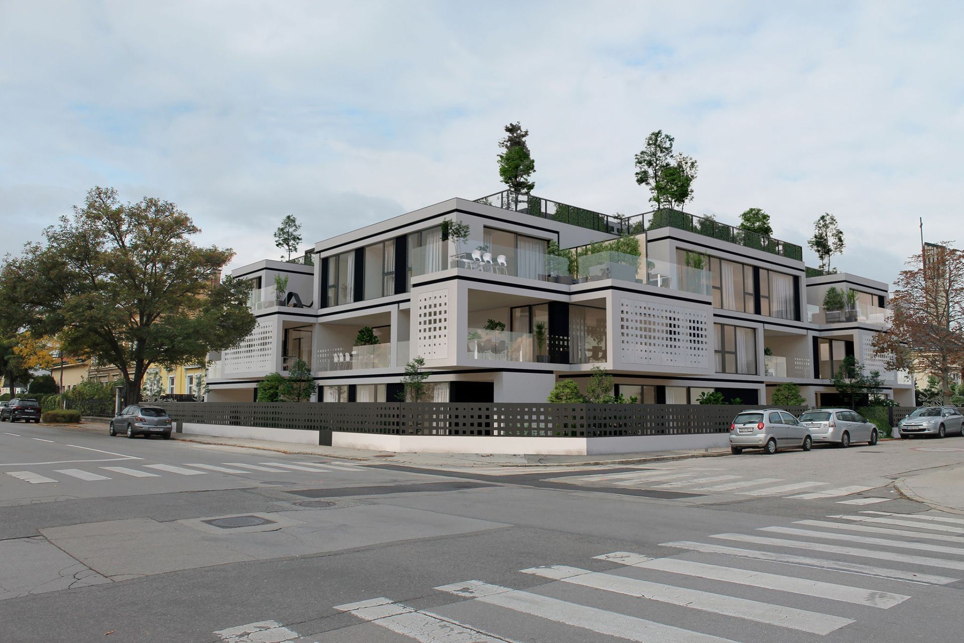 Modernes Mehrfamilienhaus mit Balkonen an Straßenecke